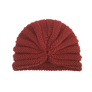 Detail of burgundy ribbed knit turban hat featuring a central knot design for infants