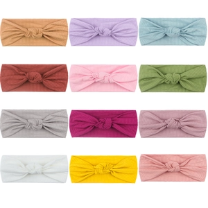 Set of 12 colorful ribbed knit elastic baby headbands with knotted bow design for infants
