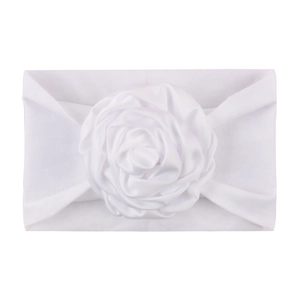 Detail of white nylon baby headband featuring a large soft satin rose flower decoration