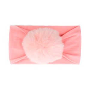 Detail of baby pink elastic nylon headband featuring a large soft decorative pom-pom