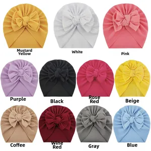Detailed color selection for ribbed knit baby hats featuring oversized bow decorations