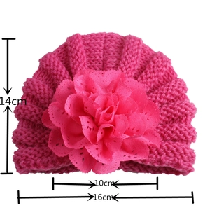 Infant rose pink knitted turban hat with large lace flower and size dimensions shown