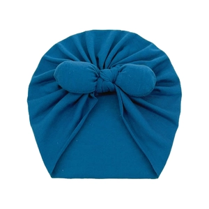 Deep teal baby turban hat with a large decorative bow made of soft knit fabric