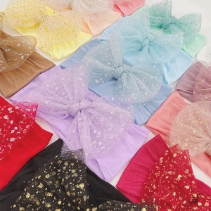 Soft nylon baby headbands with colorful tulle bows featuring gold polka dots for infants
