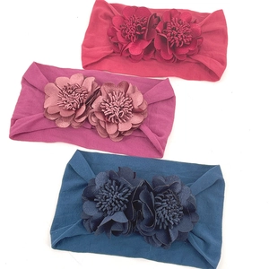 Three-pack wide nylon baby headbands with large 3D flowers in red, purple, and blue colors