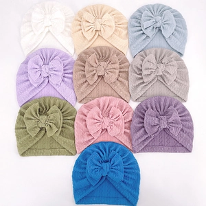 Baby turban hats with jacquard bow in ten colors including white, pink and blue