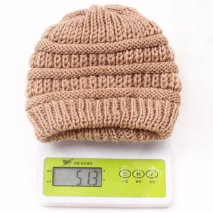 Detail showing the heavy knit texture and weight measurement of the khaki baby beanie