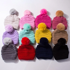 Winter knit baby beanies with faux fur pom-poms in twelve various colors collection