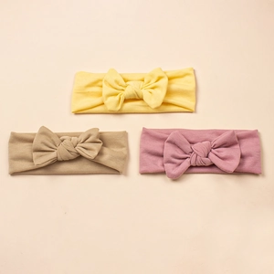Three-piece baby bow headbands in yellow, khaki, and pink soft knitted cotton fabric