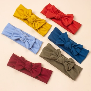 Detailed set of six colorful elastic knitted baby headbands with large soft bow knots