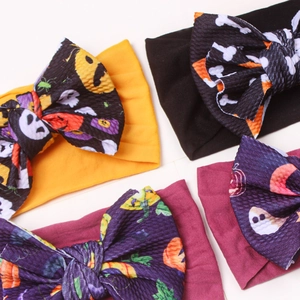 Halloween baby headband set with pumpkin and skull pattern on large ribbed bows
