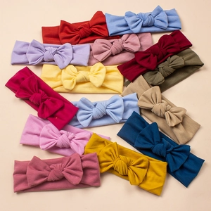 Macro shot of colorful soft cotton baby bow headbands in various solid ribbed knit colors