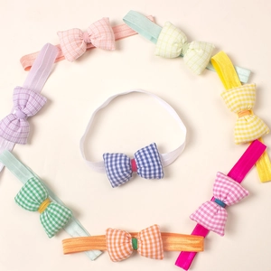Set of 8 colorful plaid bow headbands for babies featuring soft elastic nylon bands