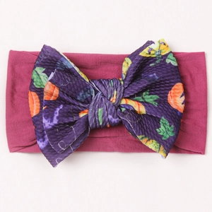 Magenta nylon baby headband with purple knit pumpkin pattern bow for Halloween