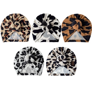 Set of five baby leopard and cow print donut knot hats in soft stretch knit cotton