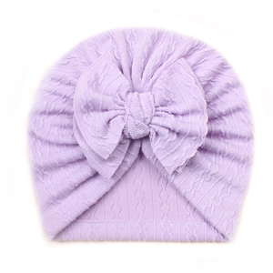 Detail of lavender cable knit baby turban hat with a large decorative bow tie