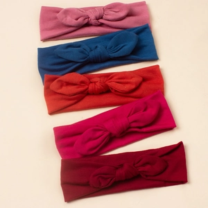 Lot de cinq bandeaux bébé doux avec nœuds oreilles de lapin en tons roses et rouges