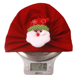 Detail showing red baby Christmas beanie weight of 21g with 3D Santa Claus decoration