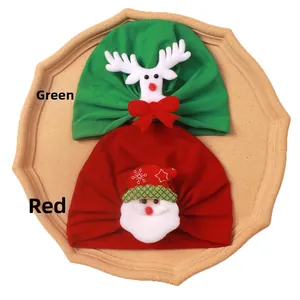 Detail of red Santa and green reindeer knit baby hats for Christmas festive wear