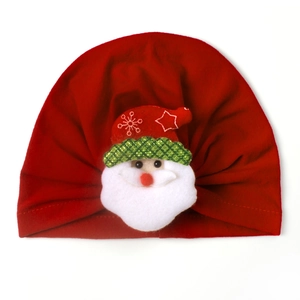 Detail of red infant turban hat with 3D Santa Claus plush doll for Christmas season