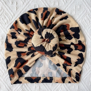 Detail of baby leopard print turban hat with a soft donut knot and knit texture