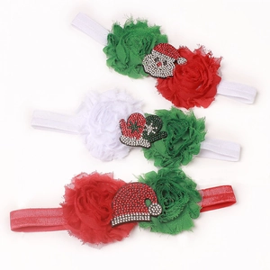 Close-up of three baby Christmas headbands featuring chiffon flowers and rhinestone patches