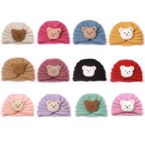 Knitted baby beanies with cute bear patch available in 12 vibrant assorted colors