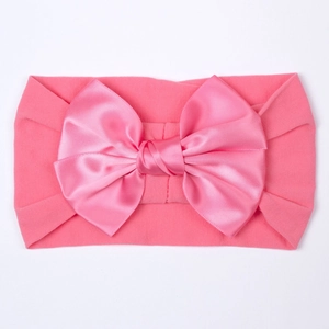 Bandeau élastique rose pour bébé en nylon avec un grand nœud en satin pour filles