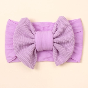Weiches lila Baby-Stirnband aus Nylon mit großer Schleife im süßen Candy-Farbstil
