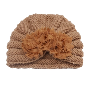 Close-up of brown knit baby turban hat with three decorative 3D mesh flowers