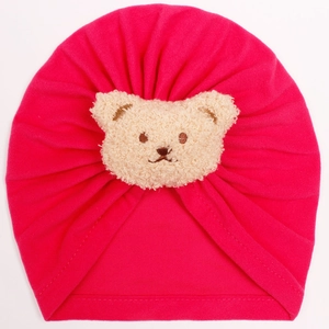 Detail of rose red baby turban hat with a cute beige plush teddy bear embroidery
