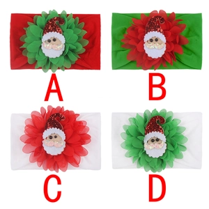 Detail of Christmas baby nylon headbands with layered chiffon flowers and Santa felt appliques