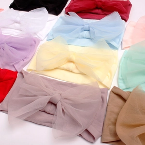 Flat lay macro of multi-color nylon mesh bow headbands for infants and baby girls