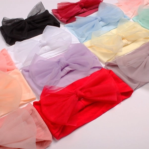 Close-up of colorful nylon mesh bow headbands for babies in various bright pastel colors