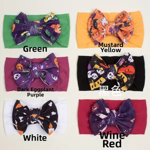 Detail view of six colored Halloween baby headbands with pumpkin and ghost bow prints
