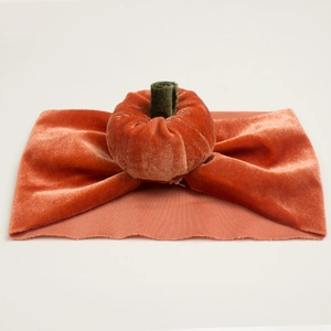 Orange velvet pumpkin headband for infants with a soft green stem for Halloween