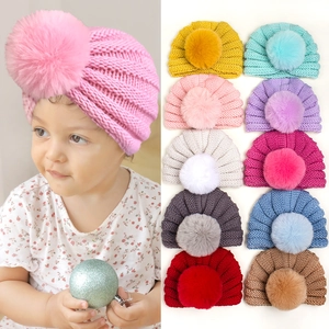 Bonnet en tricot d'hiver pour bébé avec pompon en fausse fourrure et protège-oreilles