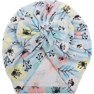 Detail of light blue floral baby turban hat featuring a large soft knit decorative bow