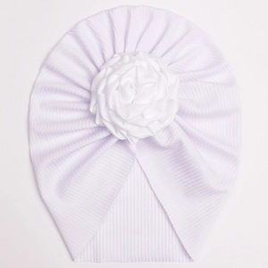 Detail of white ribbed baby turban with a large satin rose flower accessory