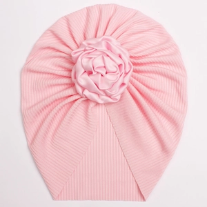 Pink ribbed baby turban hat featuring a large silk rose for infants and toddlers