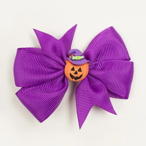 Detail of purple ribbed ribbon bow with wizard hat pumpkin for Halloween hair clip