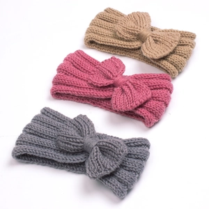 Three-piece set of knitted baby headbands in khaki, pink, and grey with bow detail
