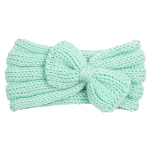 Detail of mint green cable knit baby headband with a large handmade bow decoration