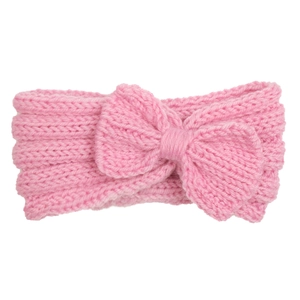 Close-up of pink knitted baby headband with a large bow detail and soft texture