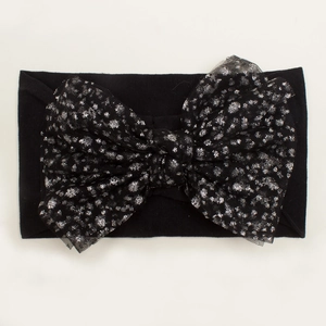 Close-up of black nylon headband with a large silver speckled mesh bow for babies