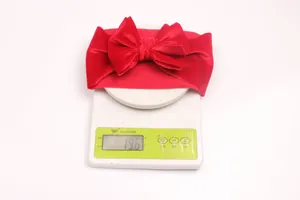 Detail view of a lightweight red velvet baby bow headband weighing approximately 19.6g