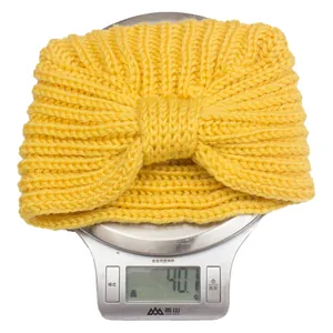 Knitted baby beanie hat with large bow knot in yellow, warm soft wool crochet style