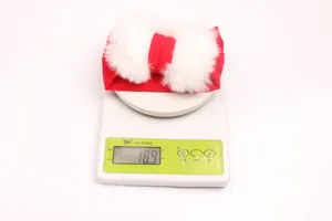 Elastic baby headband with red bow and white fluffy pom-poms for toddlers
