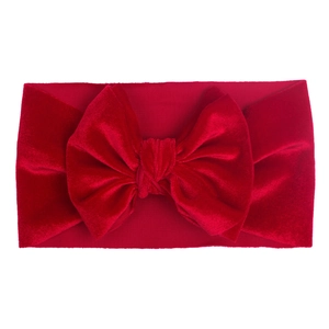Soft red velvet bow headband for infants featuring a wide knitted texture design