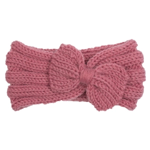Close-up of pink knitted baby headband featuring ribbed texture and a soft bow detail